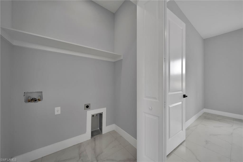 Laundry room with light marble finish flooring, washer hookup, and electric dryer hookup