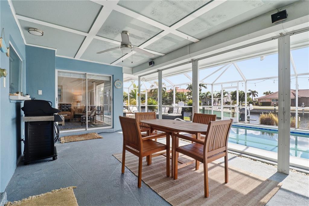 Sunroom / solarium with coffered ceiling, a water view, and plenty of natural light