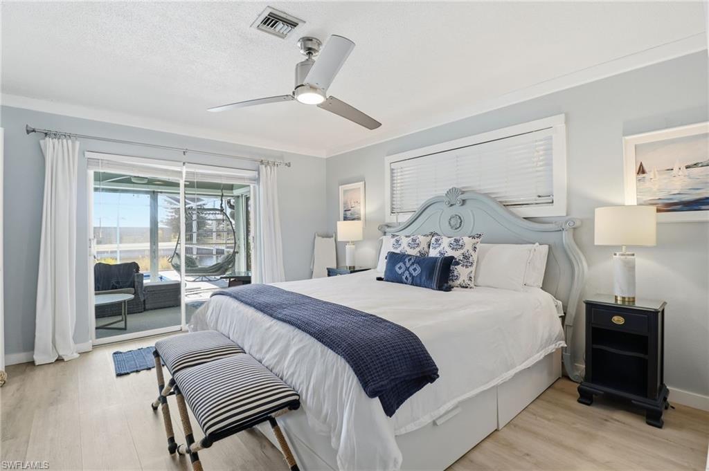 Bedroom with access to outside, light wood-style floors, and ceiling fan