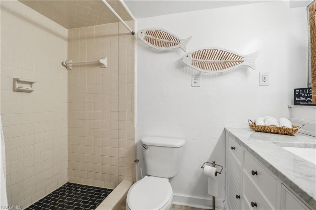 Full bath featuring vanity and a shower stall
