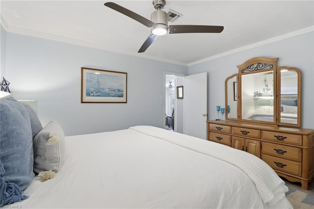 Bedroom with ornamental molding and ceiling fan