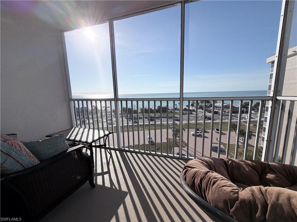 Sunroom featuring plenty of natural light and a water view