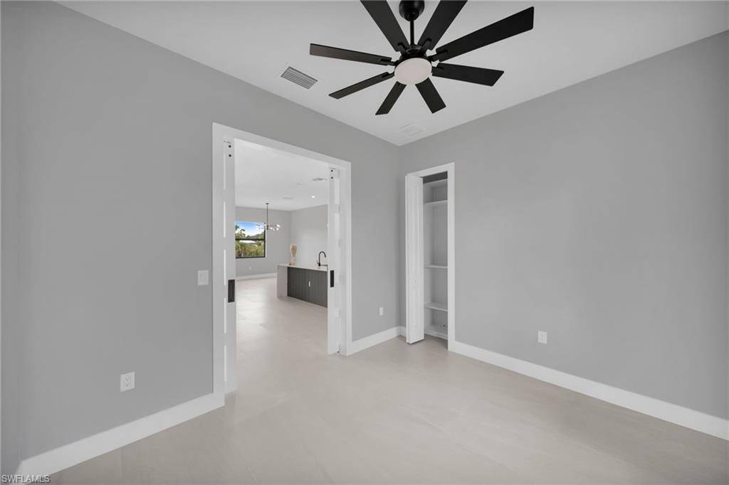 Unfurnished bedroom featuring ceiling fan and baseboards