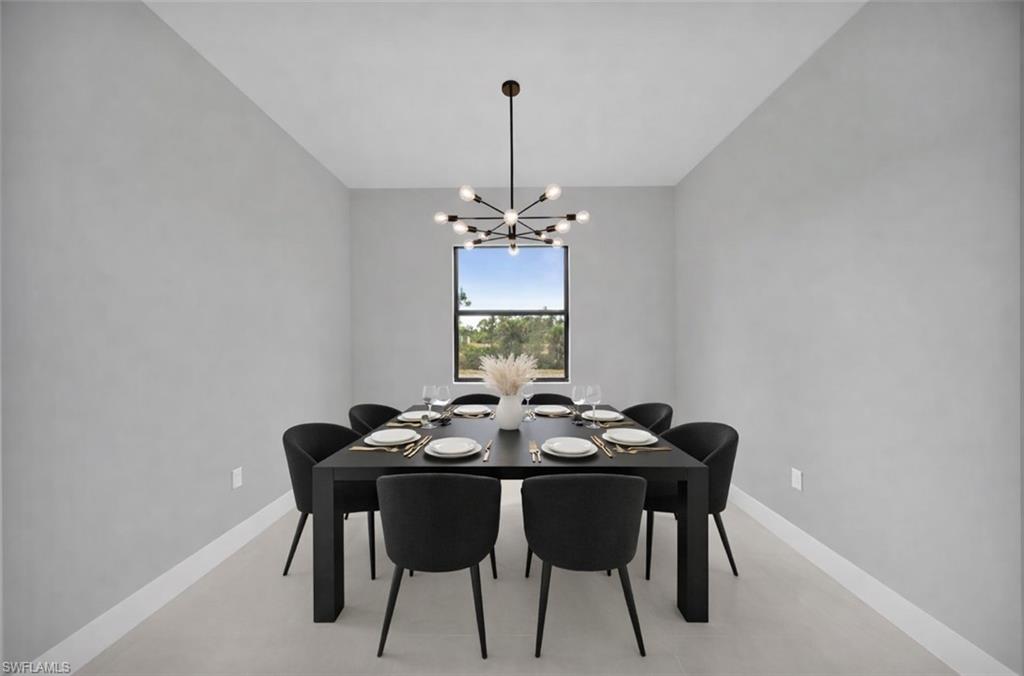 Dining room featuring baseboards and a chandelier