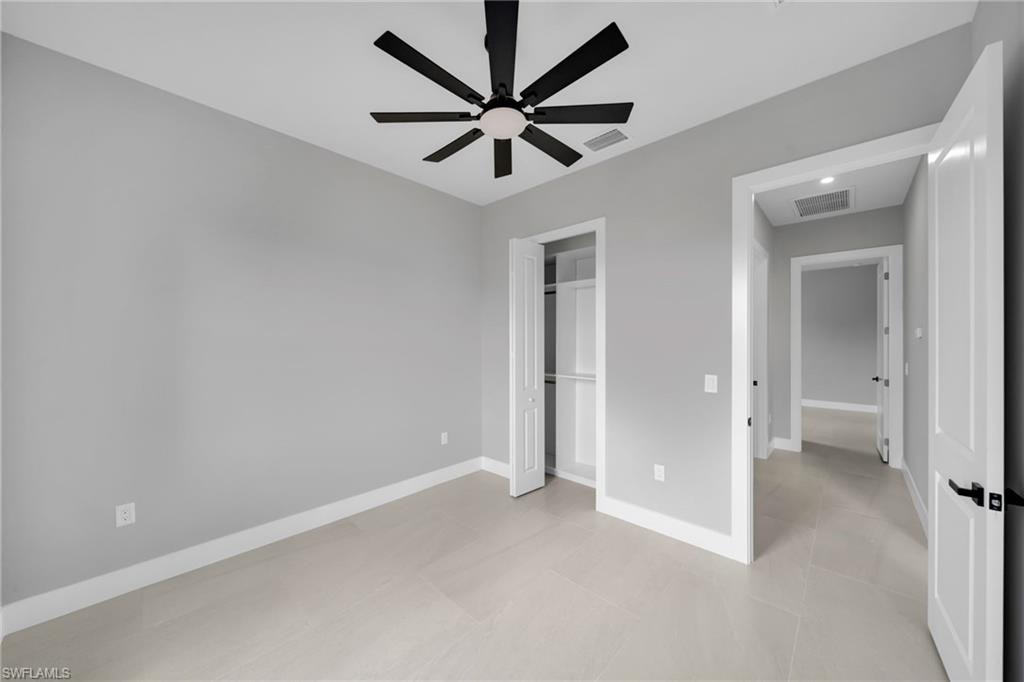 Unfurnished bedroom featuring a ceiling fan and a closet