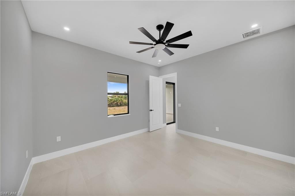 Empty room with recessed lighting, ceiling fan, and light floors