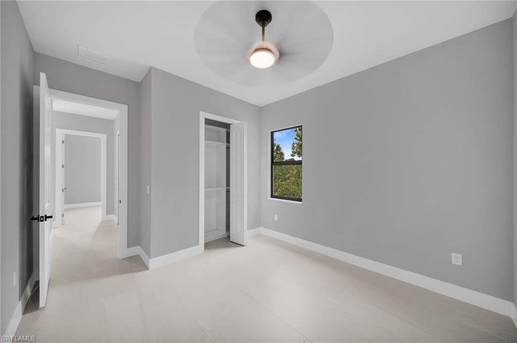 Unfurnished bedroom featuring baseboards and ceiling fan
