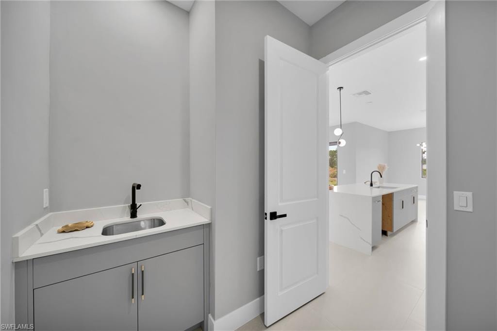 Bathroom featuring vanity and light flooring