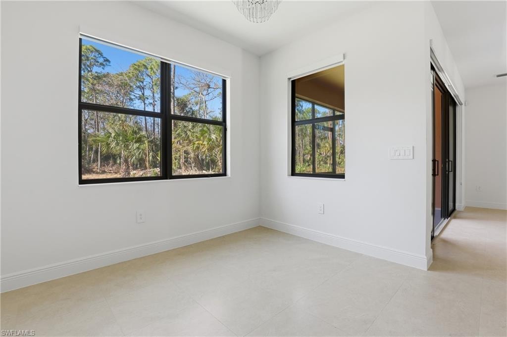 Unfurnished room featuring baseboards