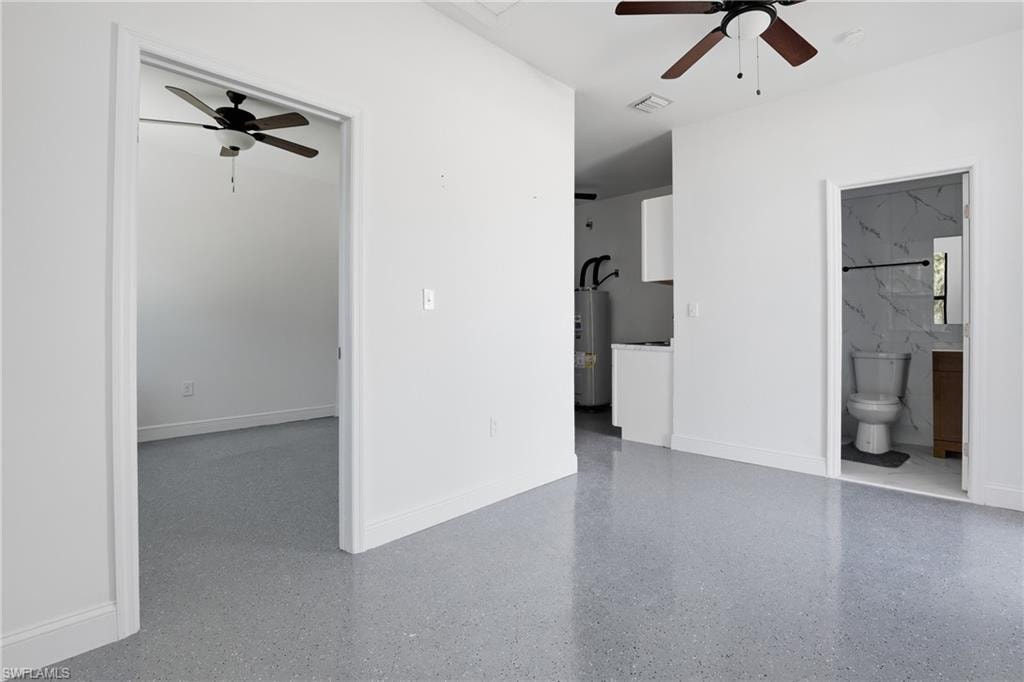 Unfurnished living room with ceiling fan and water heater