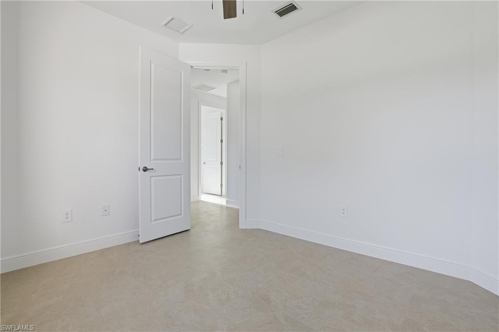 Empty room with concrete floors and ceiling fan
