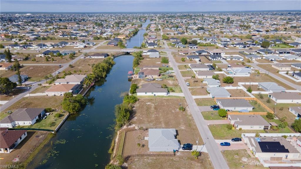 Aerial view of property's location featuring nearby suburban area and a large body of water
