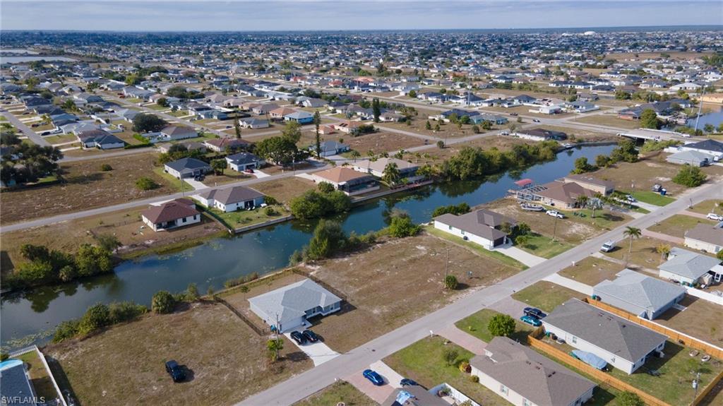 Aerial overview of property's location with nearby suburban area and a nearby body of water