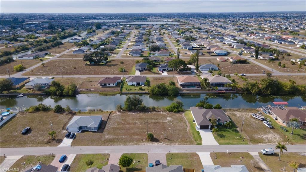 Aerial view of property's location with nearby suburban area and a nearby body of water