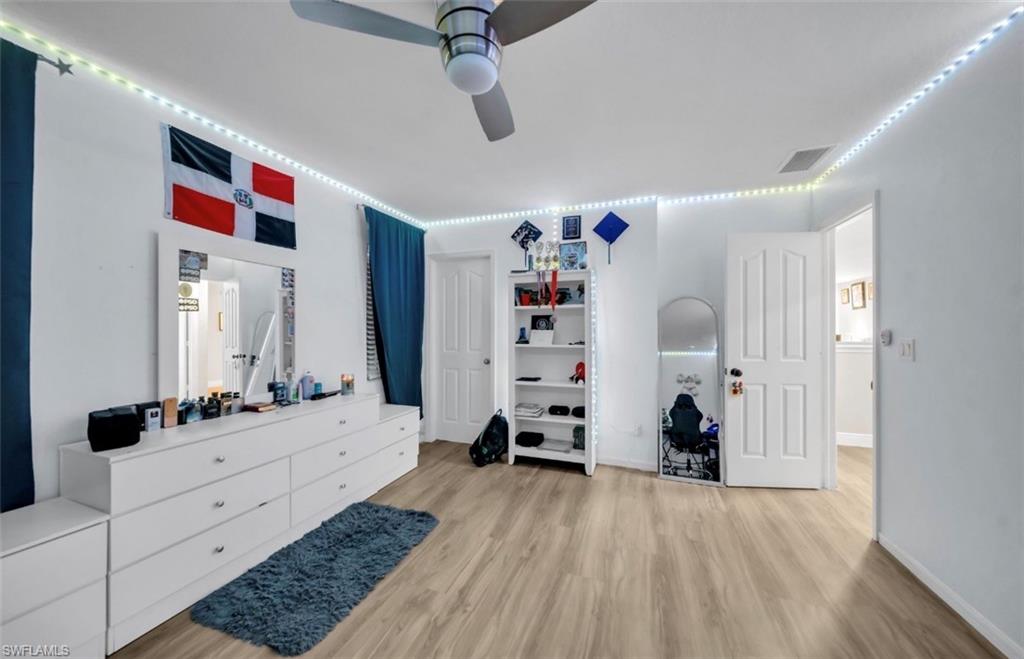 Bedroom with a ceiling fan and light wood-type flooring