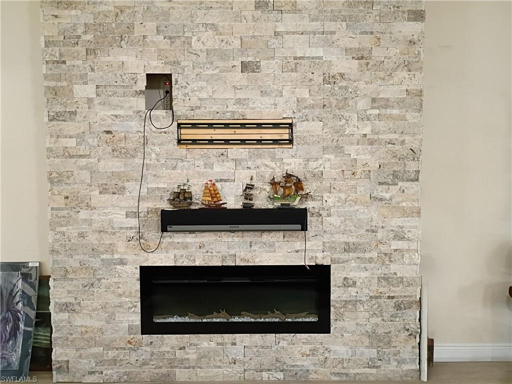Detailed view of a stone fireplace and baseboards