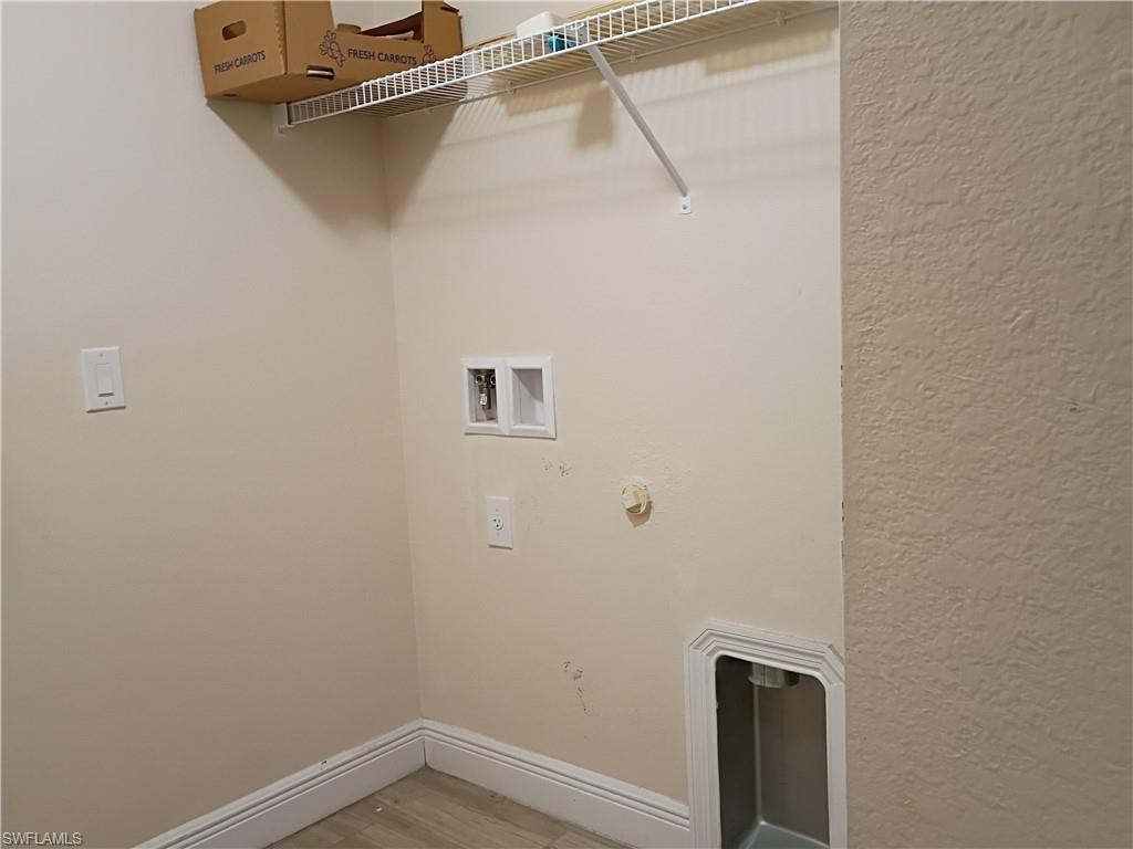 Laundry area with gas dryer hookup, light wood-type flooring, and hookup for a washing machine