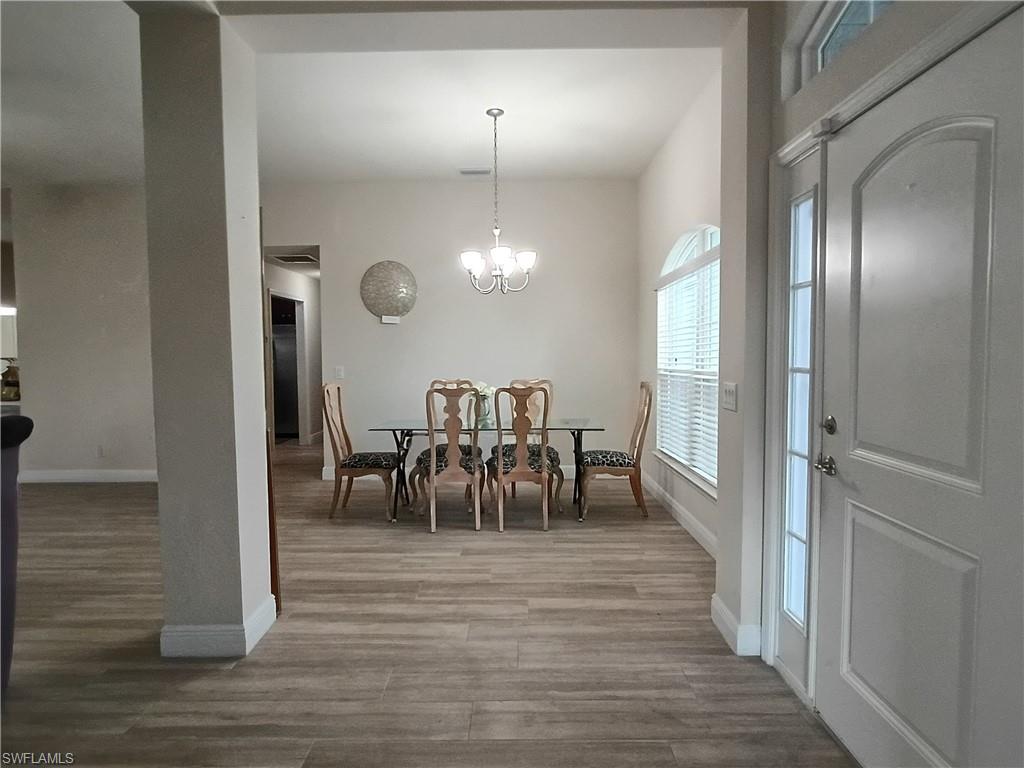 Dining room featuring a chandelier and light wood finished floors