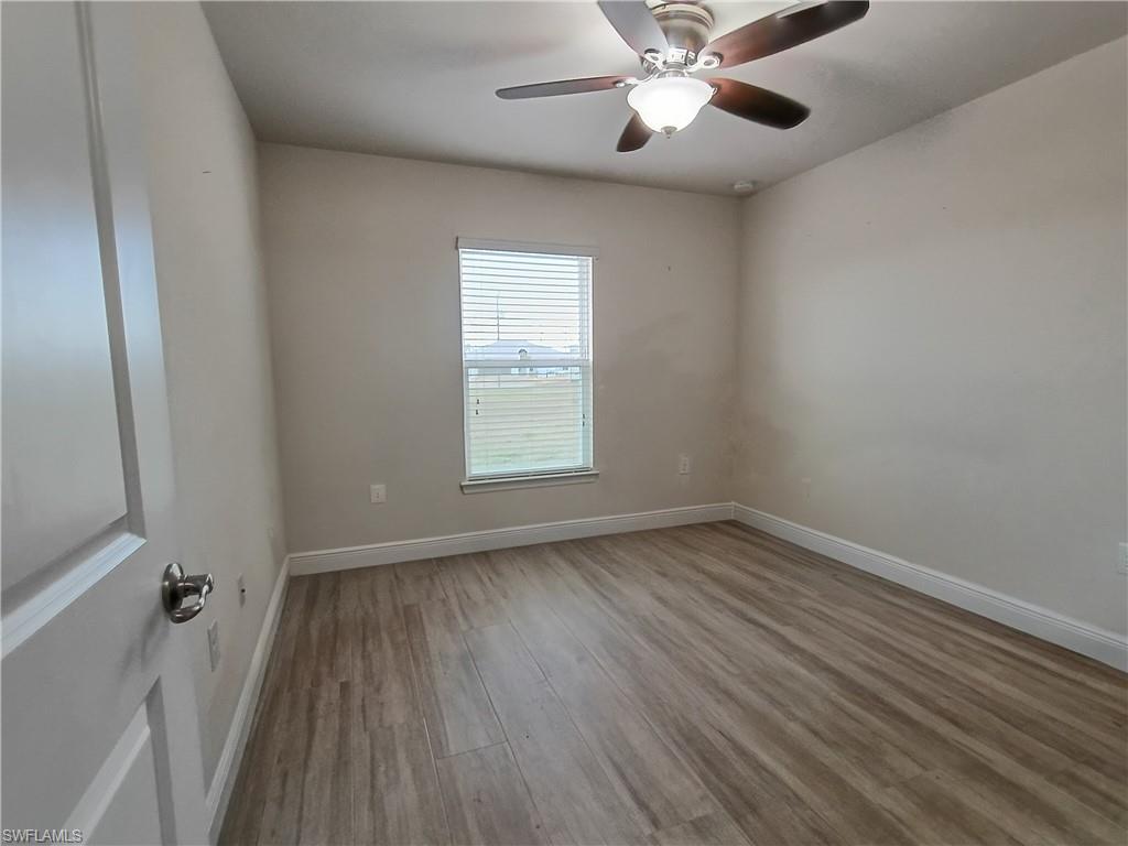 Unfurnished room with light wood-type flooring and a ceiling fan