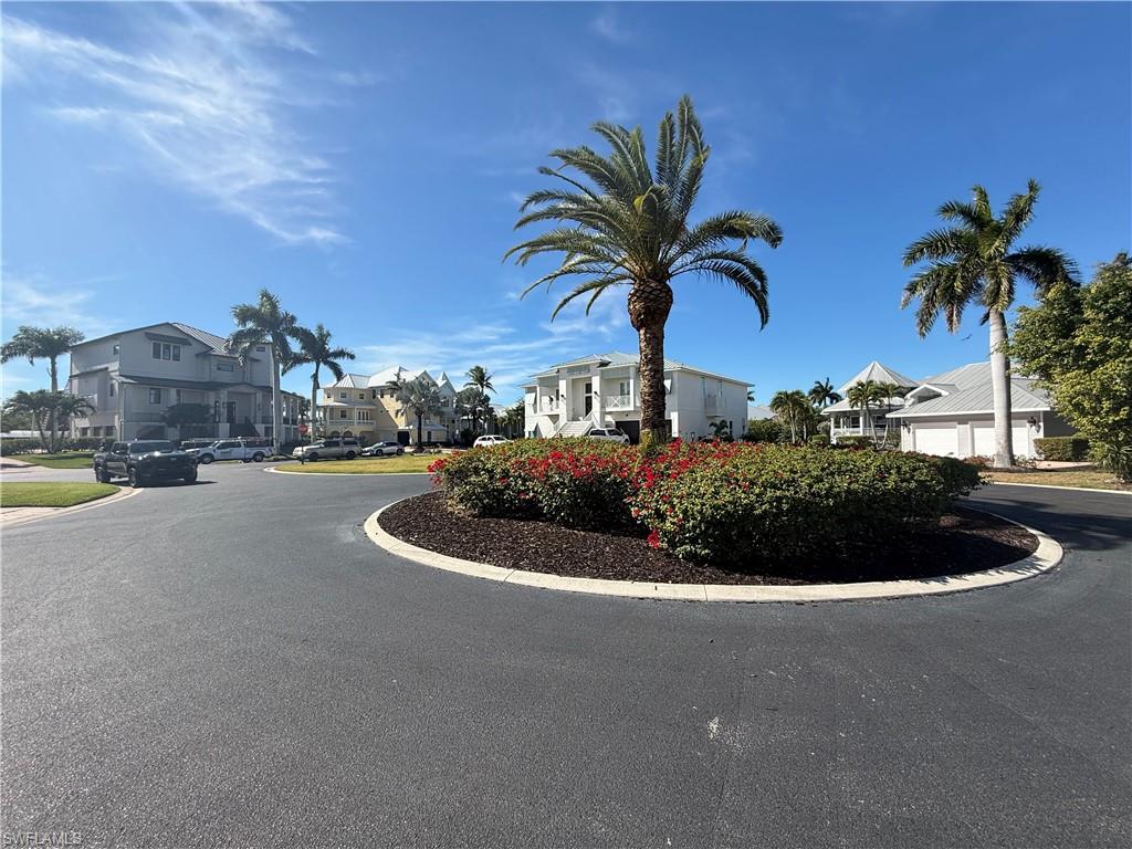 View of asphalt road with curbs and a residential view