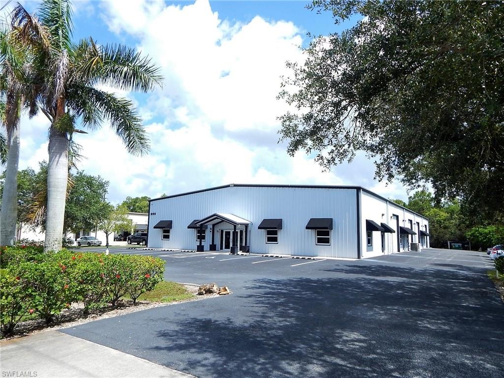 View of property featuring uncovered parking