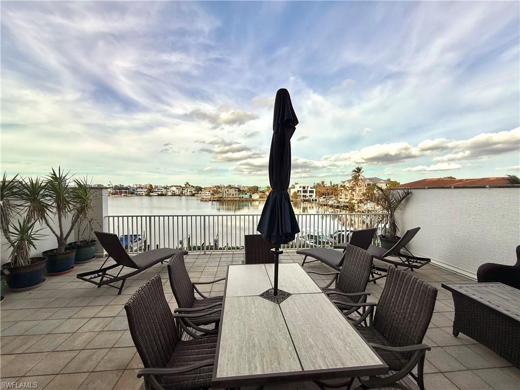 View of patio / terrace featuring outdoor dining space and a water view