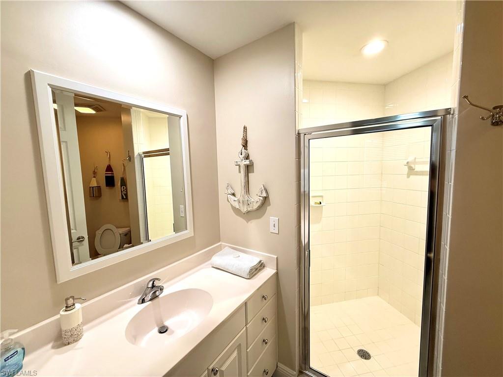 Bathroom with vanity and a shower stall