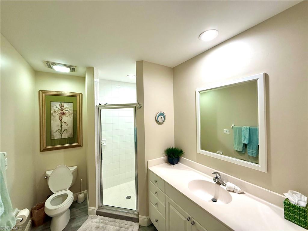 Full bathroom featuring vanity and a stall shower