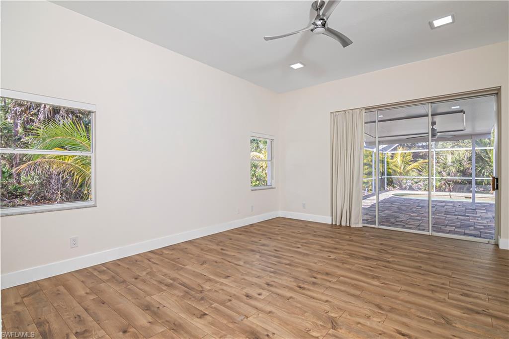 Empty room with wood finished floors and ceiling fan