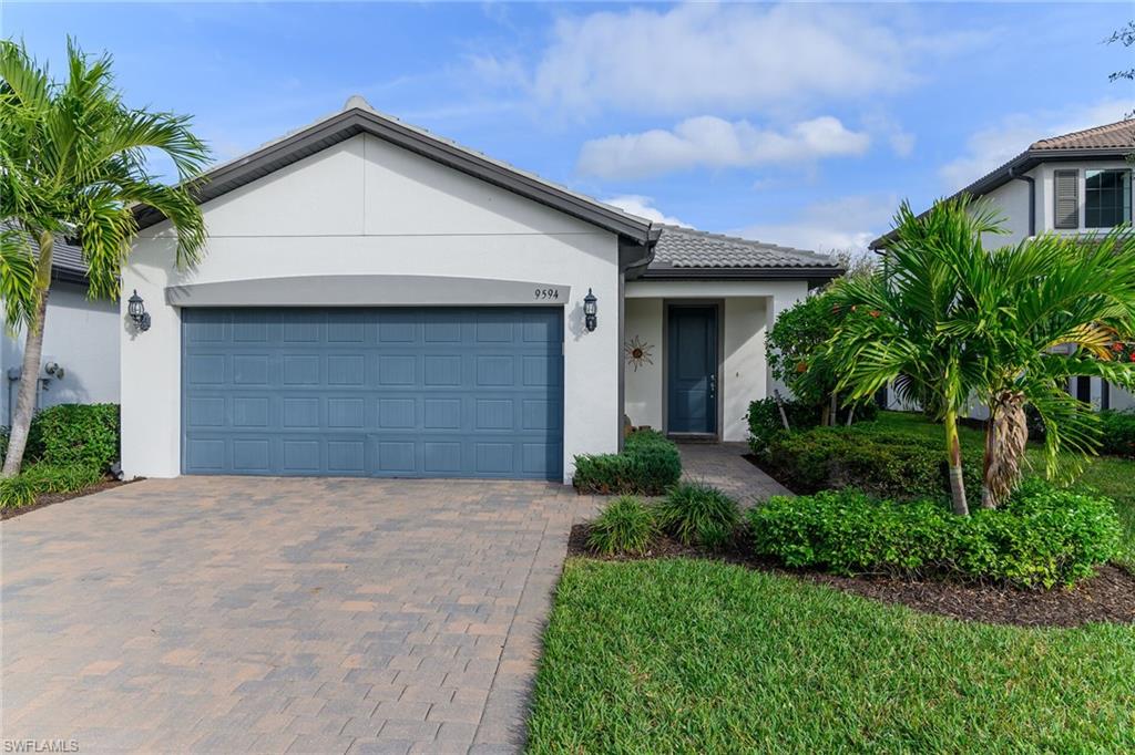 Ranch-style home with stucco siding, decorative driveway, and a garage
