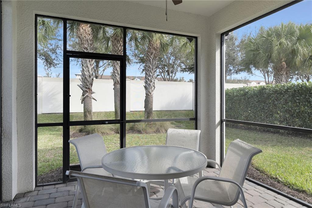 Sunroom / solarium featuring outdoor dining space and a ceiling fan