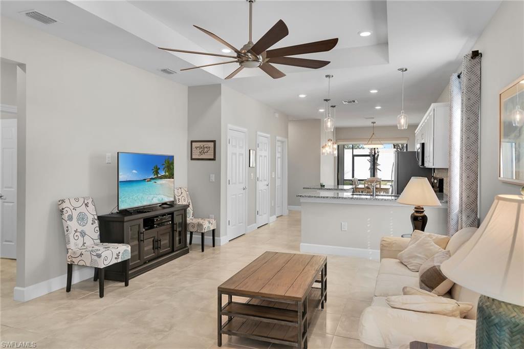 Living area featuring recessed lighting, ceiling fan, and a chandelier