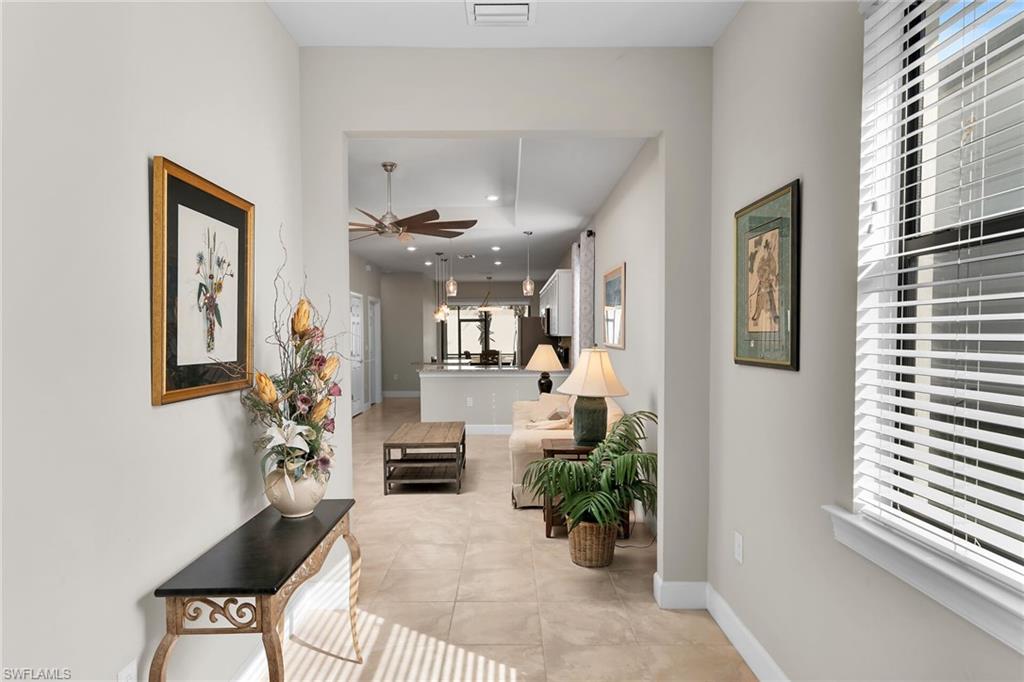 Hallway featuring recessed lighting and light tile patterned floors