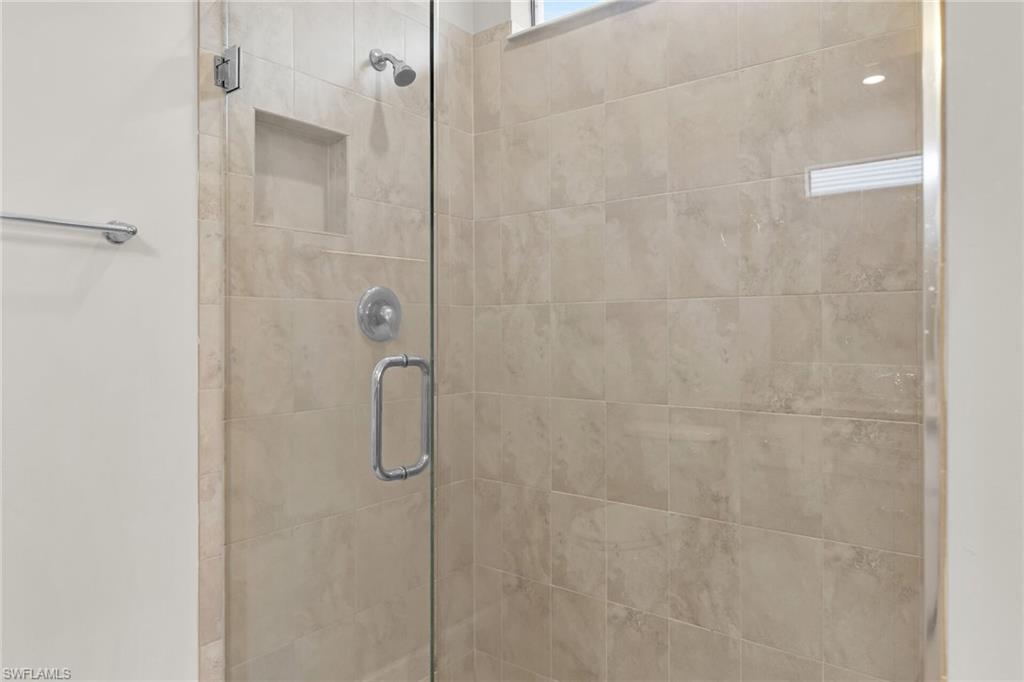 Full bath featuring a shower stall