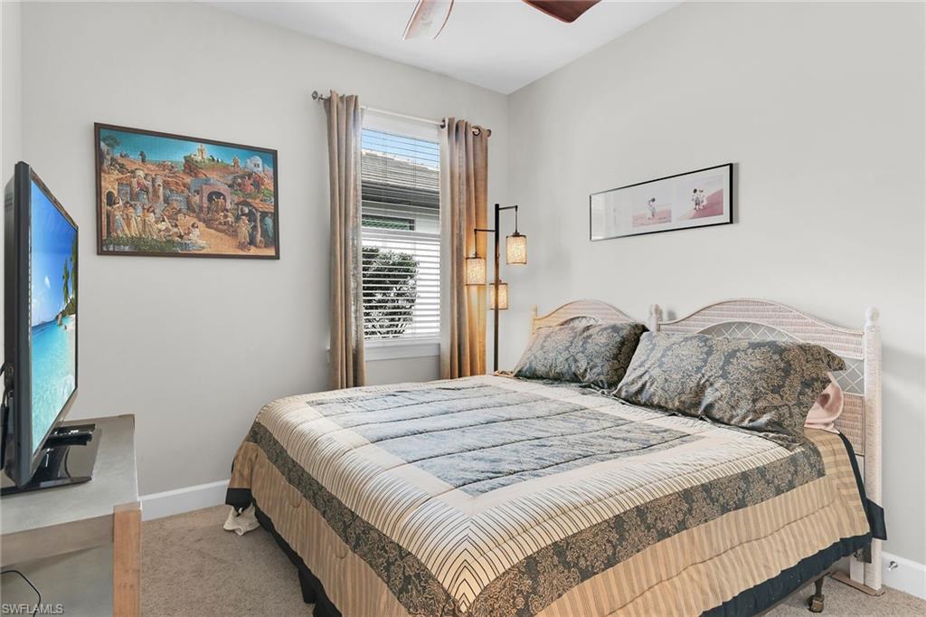 Bedroom featuring light carpet and a ceiling fan