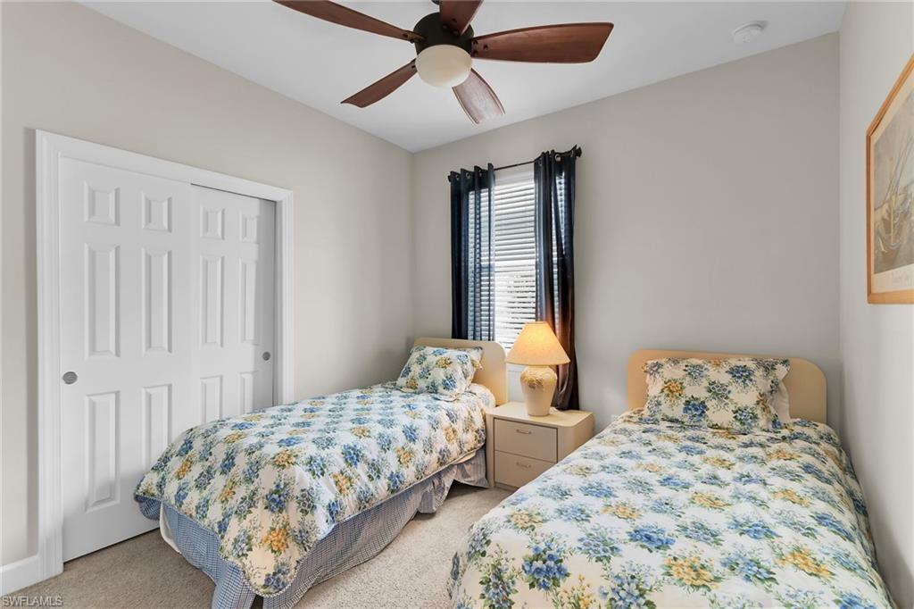 Bedroom with carpet floors, ceiling fan, and a closet