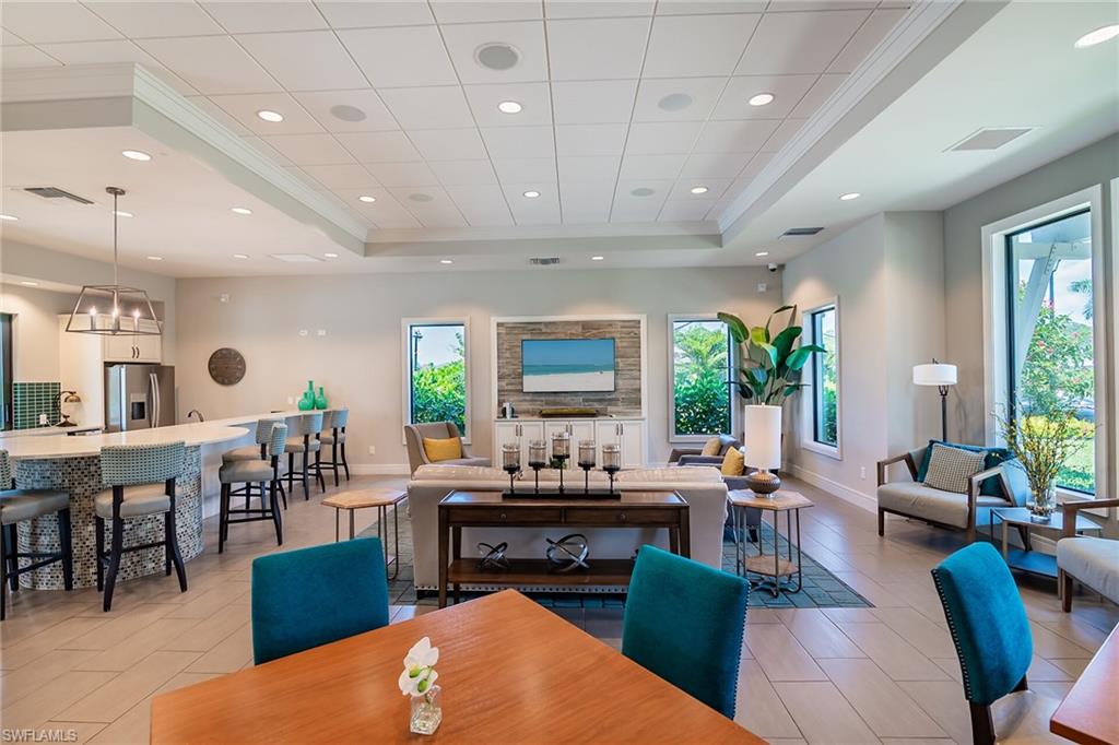 Dining space featuring a chandelier, recessed lighting, a tray ceiling, and crown molding