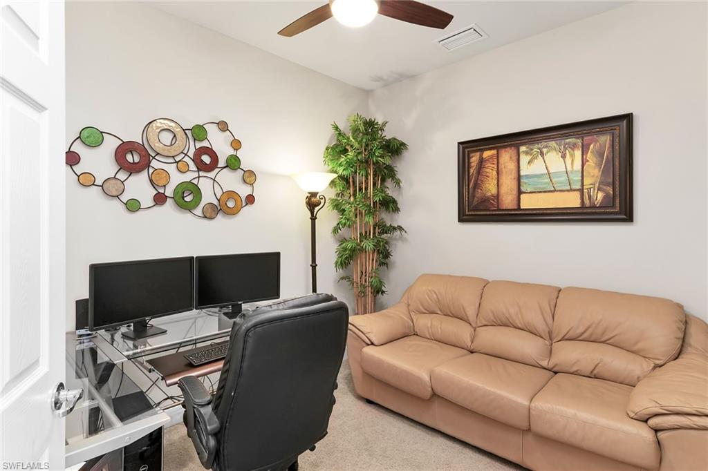 Home office with carpet flooring and a ceiling fan