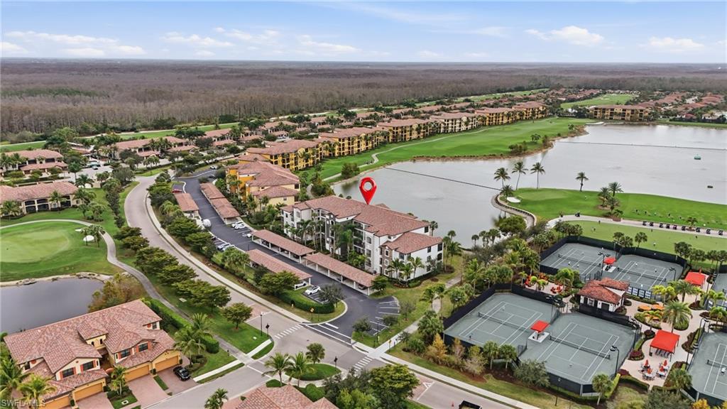 Aerial view of residential area featuring a local golf course and a nearby body of water