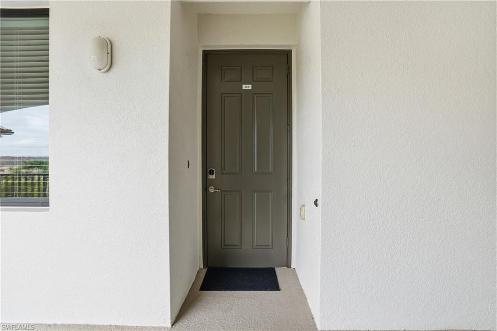 Doorway to property with stucco siding