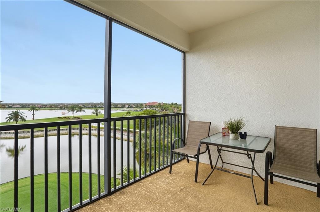 Balcony featuring a water view and a sunroom