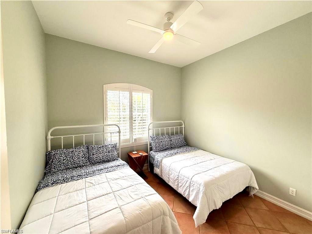 Bedroom featuring ceiling fan and dark tile patterned flooring