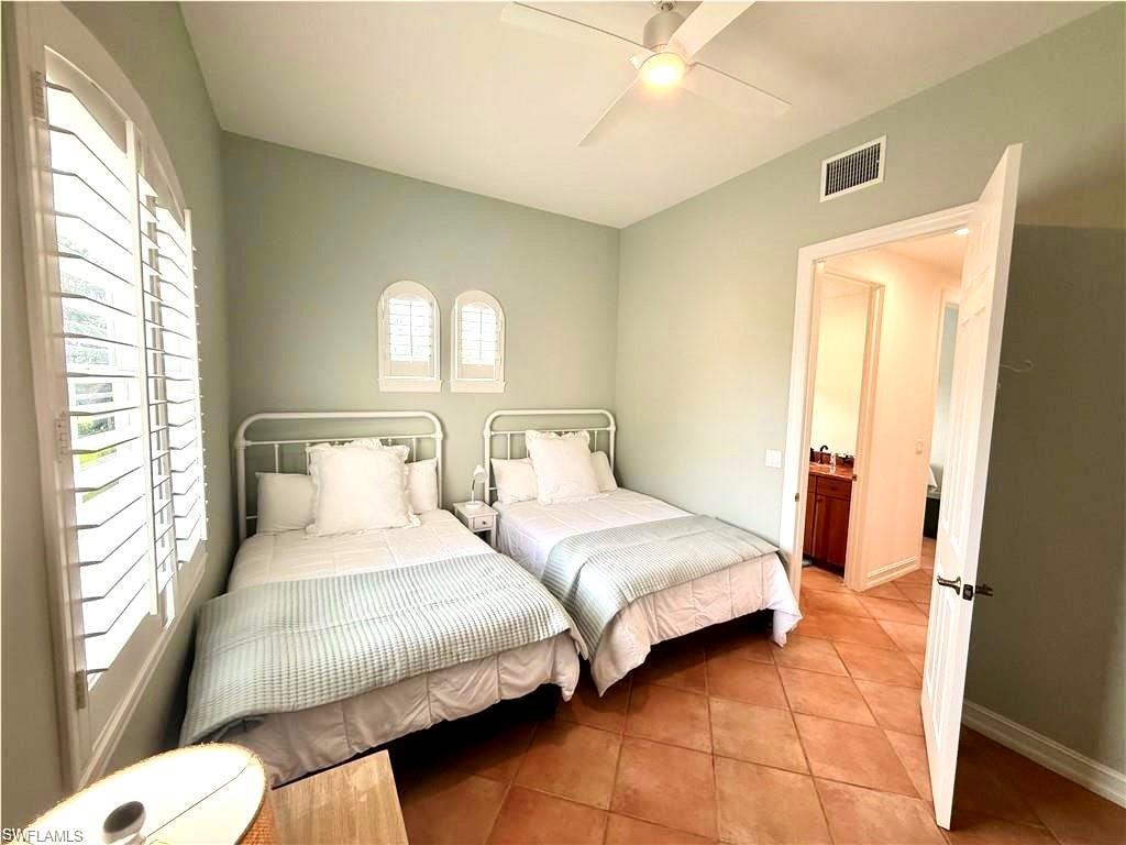Bedroom featuring tile patterned floors and a ceiling fan