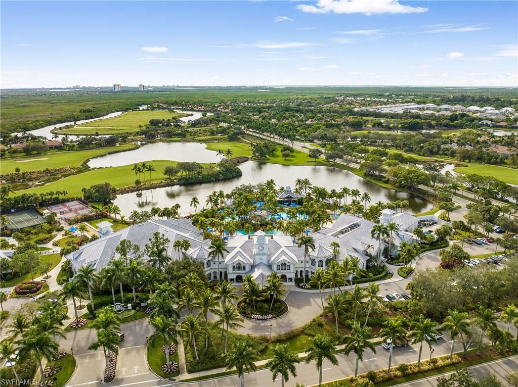 Aerial overview of property's location featuring a nearby body of water and a local golf course