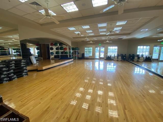 Workout room featuring ceiling fan and a paneled ceiling