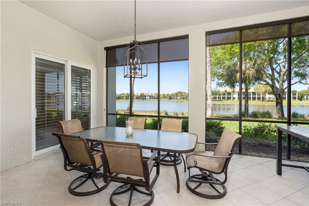 Sunroom / solarium with a chandelier, a water view, and healthy amount of natural light
