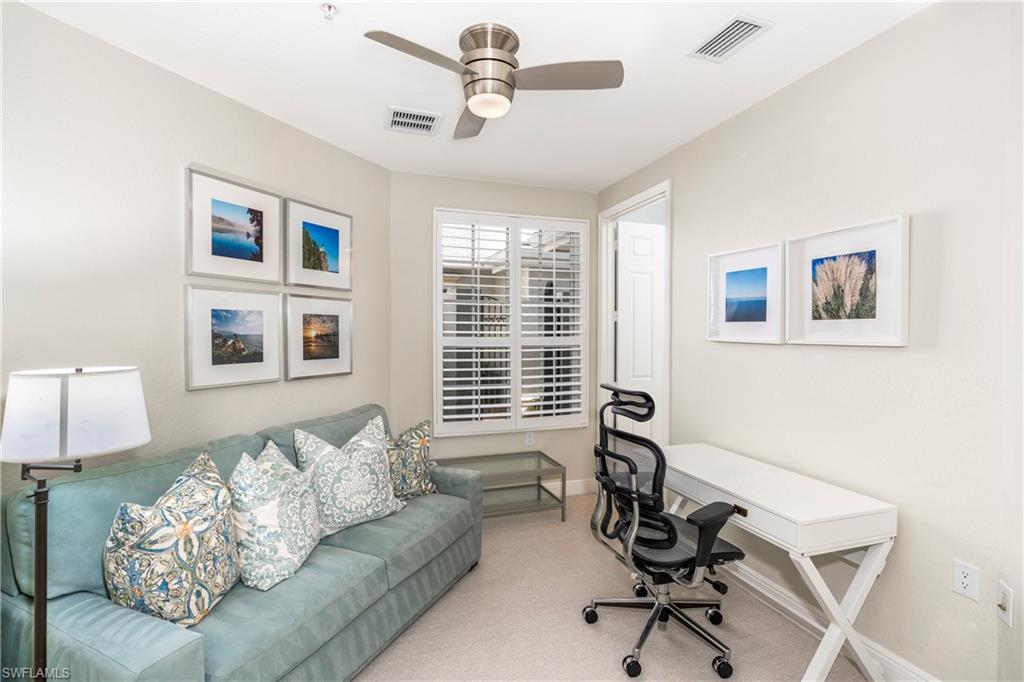 Carpeted home office featuring baseboards and ceiling fan