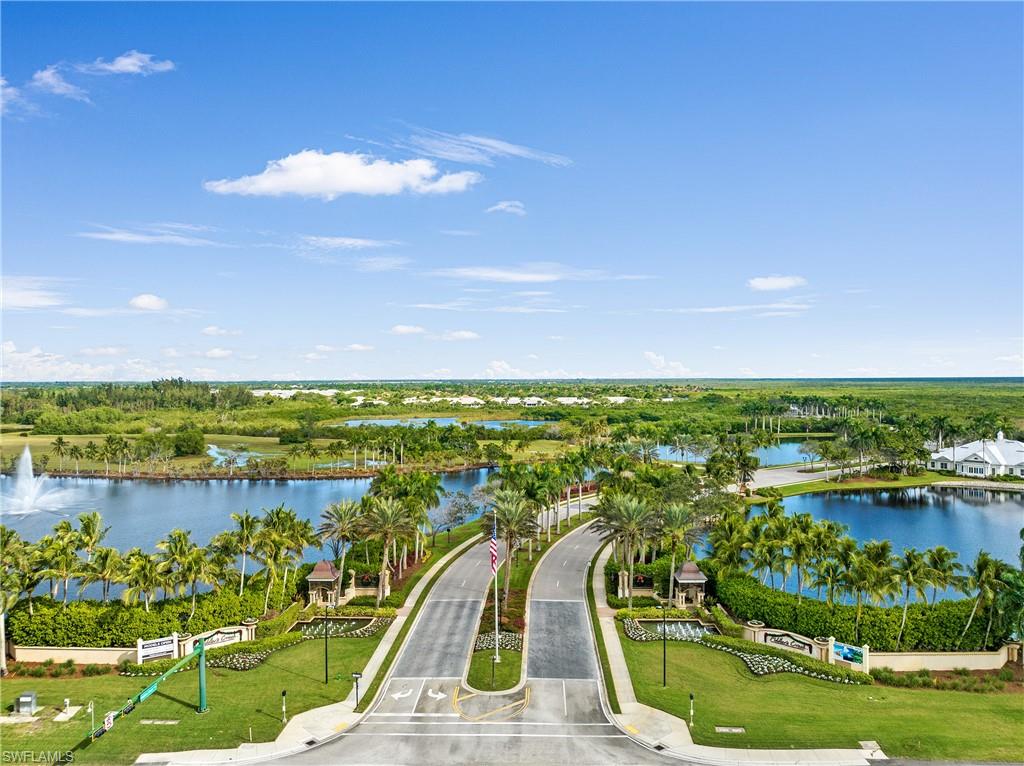 Aerial view of a nearby body of water and a tree filled landscape