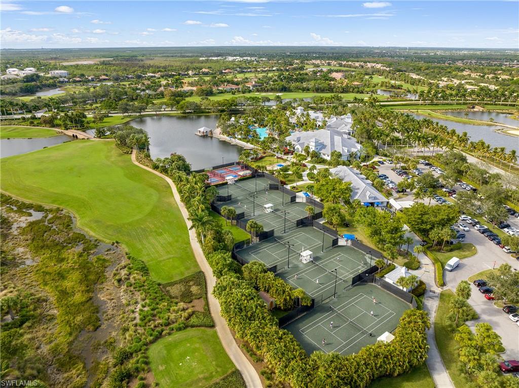 Drone / aerial view of a nearby body of water and a local golf course