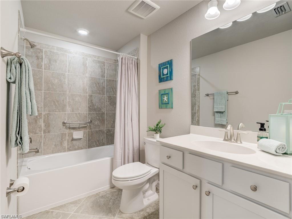 Full bathroom featuring tile patterned flooring, shower / tub combo, vanity, and toilet
